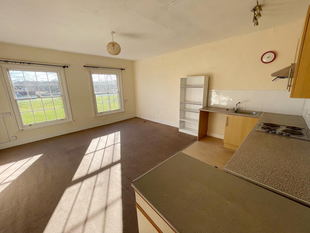 Lot: 135 - FIVE VACANT FLATS IN ONE FREEHOLD BUILDING - Living room and kitchen in flat B overlooking Sudbury Cricket Club